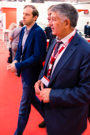 MOSCOW, RUSSIA - MAY 23, 2015: Minister of Industry and Trade of the Russian Federation Denis Manturov at the 8th Helicopter Industry Exhibition HeliRussia 2015 in Crocus Expo. Near Kozlov Grigory (R)のeditorial素材