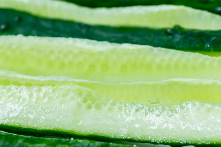 Fresh cucumbers sliced thin slices along. Closeup. Background.の写真素材