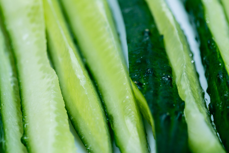 Fresh cucumbers sliced thin slices along. Closeup. Background.の写真素材