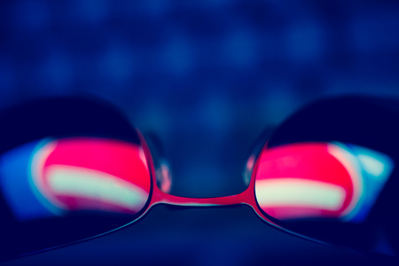 Dark sunglasses with reflection of a prohibiting road sign against a computer keyboard in the dark. The concept of anonymity in the Internet. Hacker activity.の写真素材