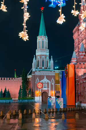 MOSCOW, RUSSIA - APRIL 30, 2018: View of the Kremlin's Nikolskaya Tower and the State Historical Museum on Red Square from Nikolskaya Street. Festive illumination. Evening. Rain.のeditorial素材