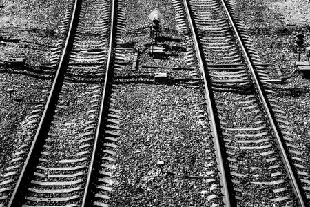 Top view of a railway track on a sunny day. Steel rails. Crushed stone. Concrete sleepers. Traffic light. Automation systemsの写真素材