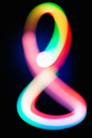 Digit 8. Eight. Glowing numbers on dark background. Abstract light painting at night. Creative...