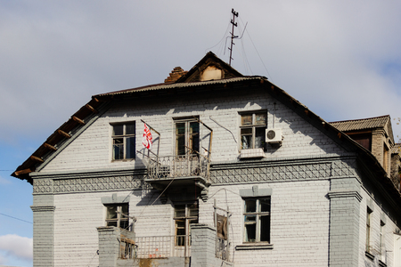 DNIPRO, UKRAINE - NOVEMBER 1, 2018: Side facade of an old building with the Polish flag on the balcony. City center.のeditorial素材
