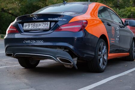 MOSCOW, RUSSIA - AUGUST 17, 2018: A CLA 200 car Mercedes Benz from car sharing company "Belka car" on toll parking. Rear bumper fell off after a traffic accident. Road crash. Damaged German automobileのeditorial素材