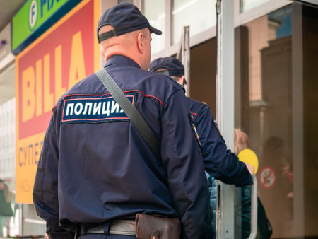 Moscow, Russia - September 14, 2019: Armed policemen enter a shopping center. Two men in police...