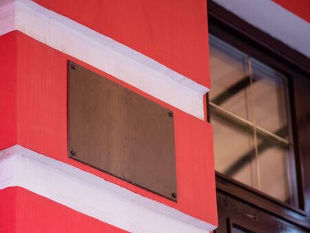 A sign at the entrance to the wall of the building. Metal plate. Template mock up. Empty copyspaceの写真素材