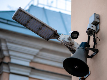 Several surveillance cameras on the wall of a house in Moscow, Russia. LED flashlight spotlight and...