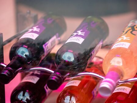 Moscow, Russia - January 17, 2020: A rack with wine bottles in a shop window display.のeditorial素材