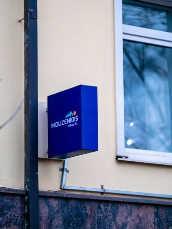 Moscow, Russia - January 17, 2020: Blue rectangular square sign Mouzenidis travel agency on the wall of the house. Travel Agency Advertisingのeditorial素材