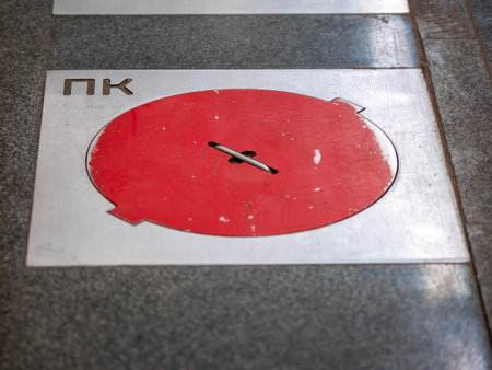 Fire hatches at the Moscow metro station. Red covers on the floor of the platform at the wells with...