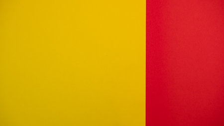 Red and yellow colored background. Colourful paper on top. Template for text or concept. Advertising mock up. Presentation flat lay mock upの写真素材