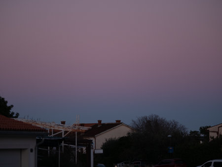 Beautiful color transitions in the sky at dusk after sunset. Natural beauty in nature. Landscape with roofs of city houses. Natural gradient background. Pula, Croatia - January 3, 2025の写真素材