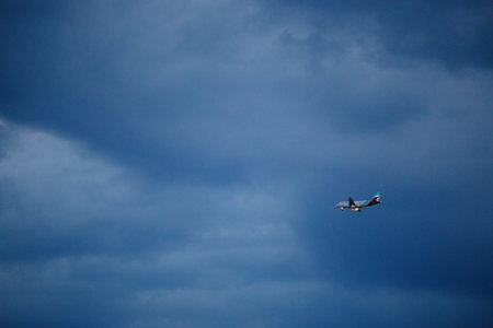 A passenger plane approaches Pula Airport for landing. The plane with its landing gear down and its...