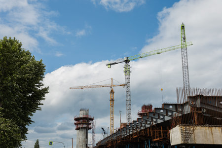 Construction site featuring multiple cranes and steel framework, showcasing active building progress...