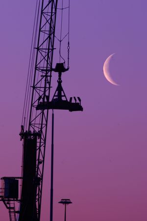 Shipyard crane against the moonlight - with plenty of copy spaceの写真素材