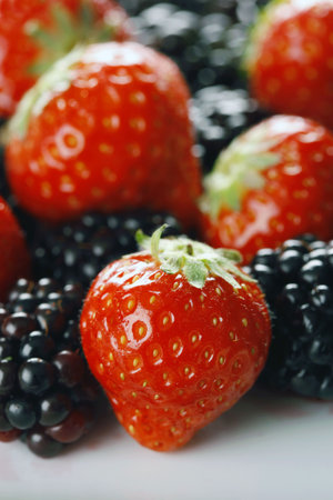 Strawberries and blackberries close-up with selective focus - shot in studio with a 21 megapixel...