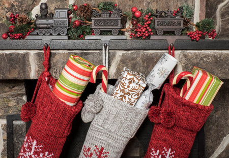 Stuffed stockings hanging on a fireplace on christmas morningの写真素材