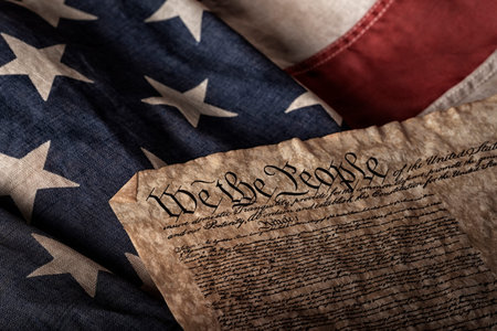 U.S. constitution on an old and worn flag