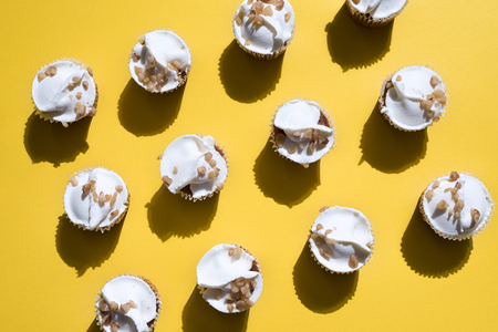cupcakes on yellow background shot directly aboveの写真素材