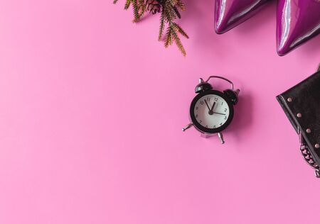 Top view of woman fashion pink shoes, black purse and Alarm clock on  pink color with neon. Party date night conception.Pink color trend concept. Copy Space for Textの写真素材