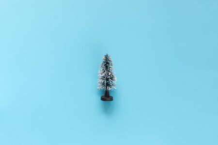 Miniature Model Winter Pine tree with snow is props decoration on a blue background. Christmas, winter, new year concept. Copy Spaceの写真素材