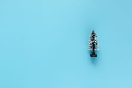 Miniature Model Winter Pine tree with snow is props decoration on a blue background. Christmas, winter, new year concept. Copy Spaceの写真素材
