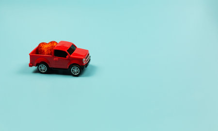 Valentines Day Concept. Miniature red toy car with red heart