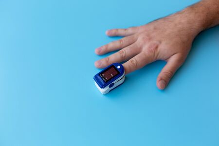 Pulse Oximeter On a male finger. Man using Oximeter. Healthy Conceptの写真素材