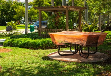 Empty playground with tables covered with orange polyethylene film and other equipment in the city park. Space for Copy. Outbreak of Coronavirus. Stay at homeの写真素材