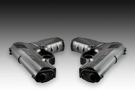 Two black guns isolated on black-white backgroundの写真素材