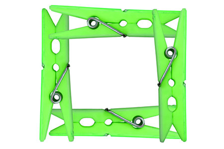 Four clothespins placed in the form of a frameworkの写真素材