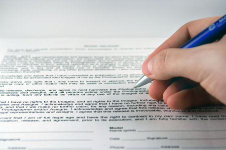 Human hand with pen makes signature on document