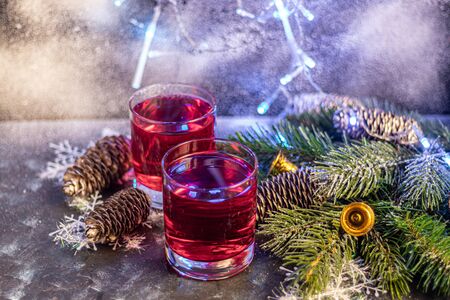 Celebratory drink, rose wine on a dark background. New Year's props, artificial snow. Copy space.の写真素材