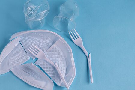 Plastic dishes, waste. The concept of recycling plastic and improving the environment. Copy space. View from above.の写真素材