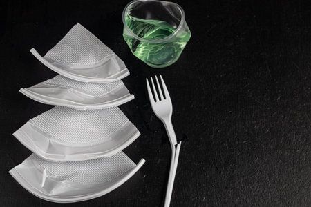 Plastic dishes, waste. The concept of recycling plastic and improving the environment. Copy space....