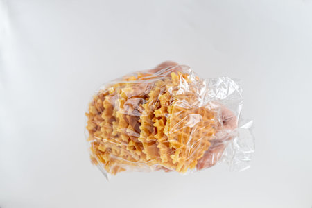 Female hand holds Viennese waffles. Inserted into the hole in a sheet of paper. Healthy eating Copy...