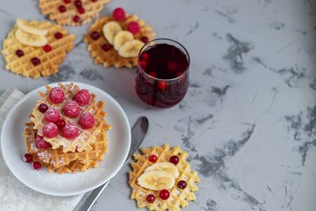 Title: Traditional Belgian waffles with fresh fruits, sprinkled with powdered sugar and cocoa. You can eat for breakfast with compote or coffee. Holiday breakfast. Copy space.の写真素材