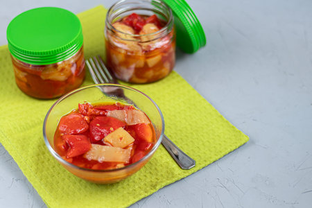 In glass jars Lecho salad of canned bell pepper and tomato. Harvesting for the winter. Vegetarian...