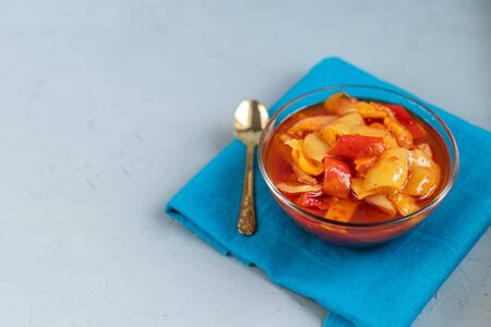 In glass jars Lecho salad of canned bell pepper and tomato. Harvesting for the winter. Vegetarian dish. Copy space.の写真素材