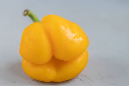 Ugly organic vegetables. Deformed home bell pepper on a light background. Foreground Copy space.の写真素材