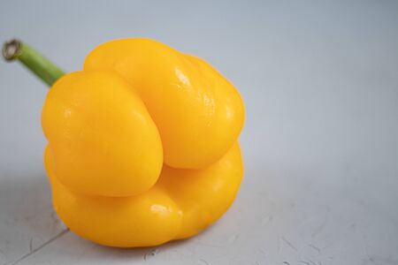 Ugly organic vegetables. Deformed home bell pepper on a light background. Foreground Copy space.の写真素材
