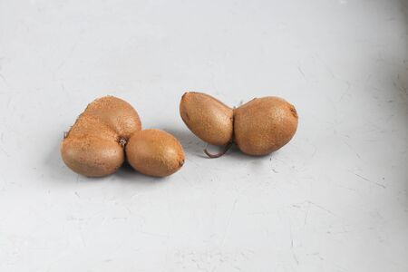 The ugly kiwi fruit. Tasty and healthy. Vegetarian food. On a light background. Copy space.の写真素材