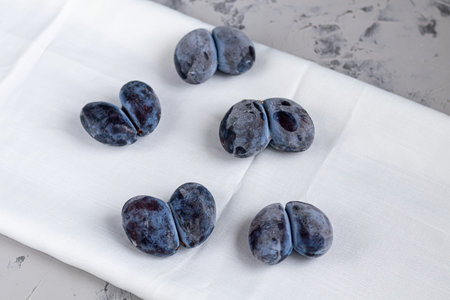 Ugly fruits. In this case, plums fused together. Tasty and healthy food. Copy space.