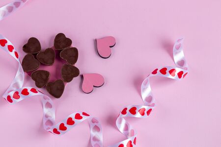 Mother's Day, Women's Day, Valentine's Day or birthday on a pink background. Hearts of different colors and caramel sticks, ribbons suitable for greeting cards. Copy space.の写真素材