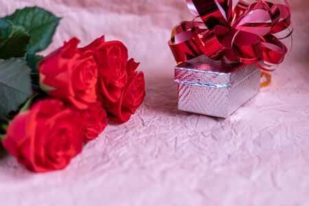Mother's Day, Women's Day, Valentine's Day or Birthday on a pink background. Roses and box packaging. Congratulatory banner, card. Copy space.の写真素材