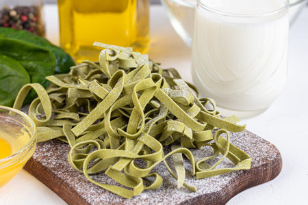 Pasta, vegetables, herbs and spices, olive oil, ingredients for Italian cuisine against white...