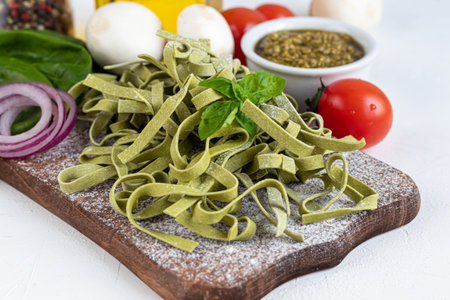 Pasta, vegetables, herbs and spices, olive oil, ingredients for Italian cuisine against white background. Copy spaceの写真素材