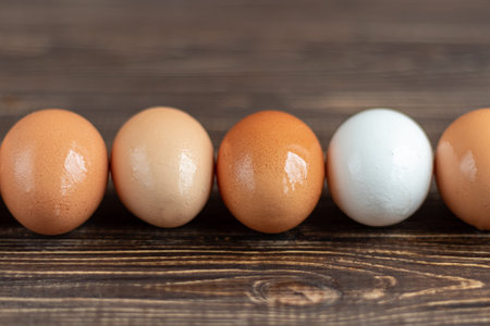 Chicken eggs on a wooden table. Agricultural products, natural eggs. Preparing for Easter. Copy...