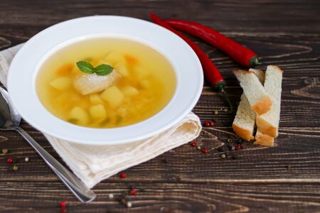 Chickpea soup on a wooden background. Near red chilli greens. Copy spaceの写真素材